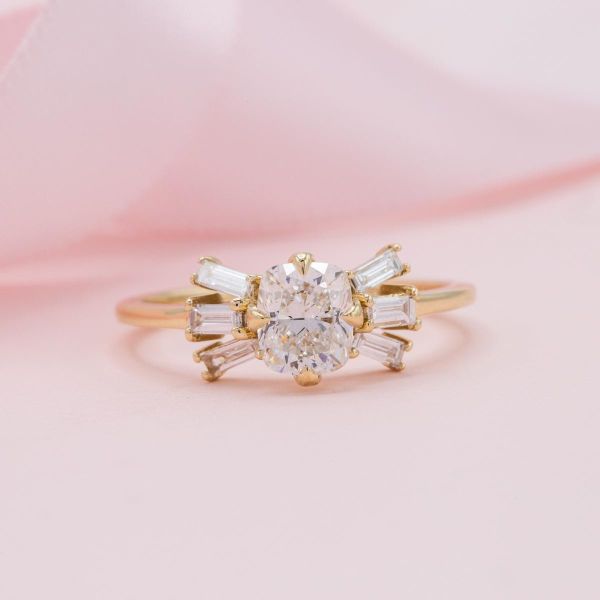 Baguette cut diamonds sit on either side of a brilliant round lab diamond in this unique engagement ring.