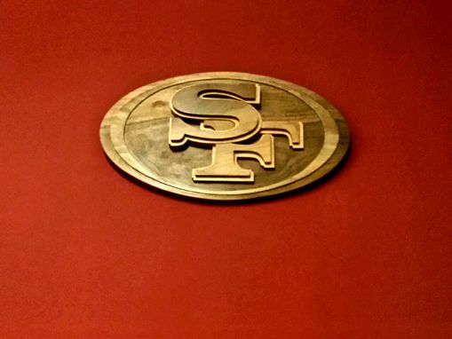 Custom Made Abstract Claro Walnut San Francisco 49ers Logo, Mounted To A Satin Finish Burgundy Red Wall
