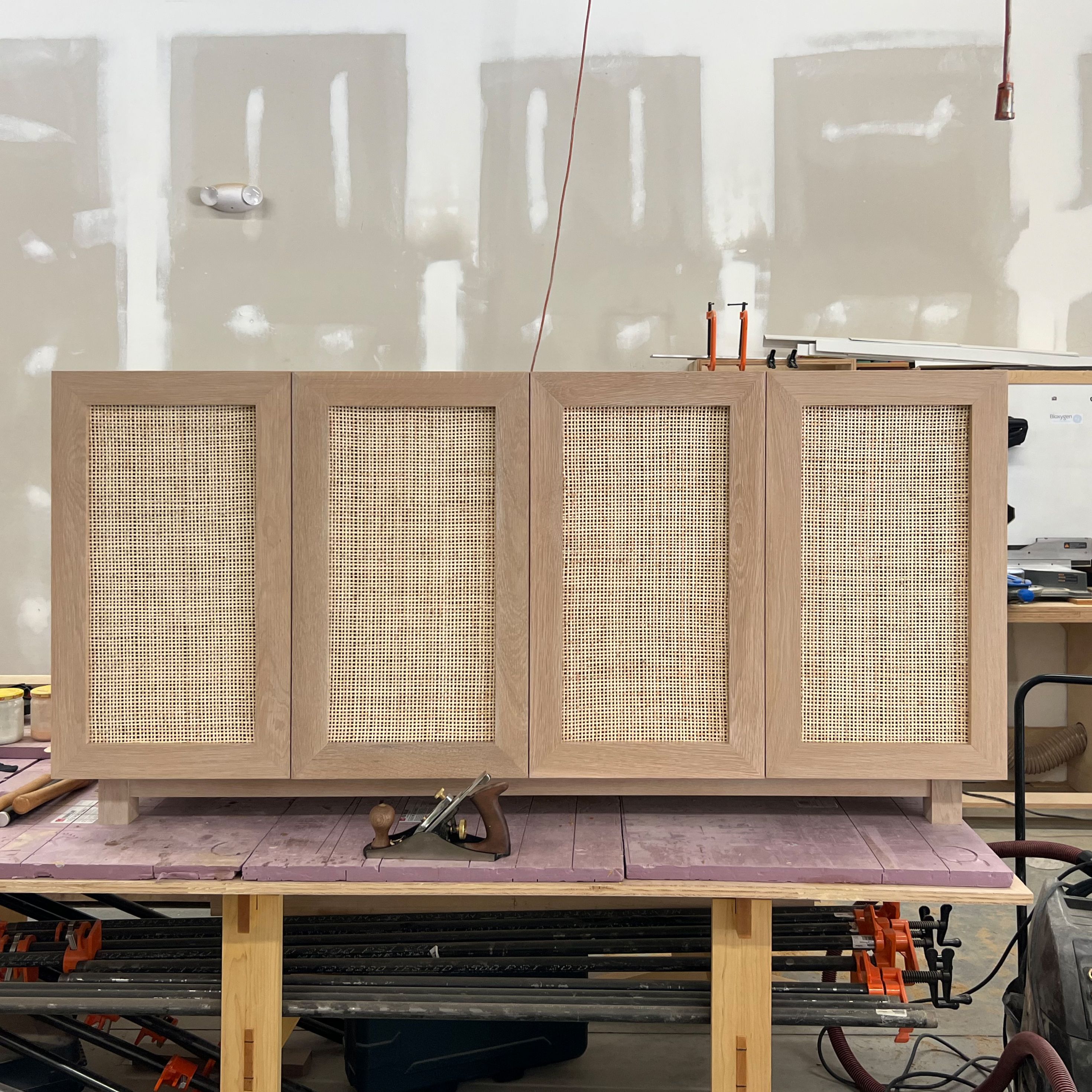 Handmade Coastal Charm White Oak Media Center With Rattan Doors by