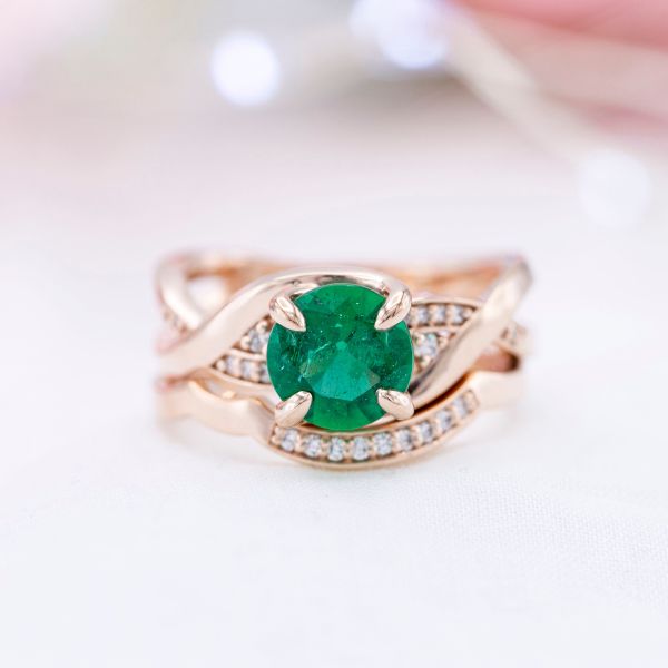 This brilliant round natural emerald has lots of visible jardin for a one of a kind feel.