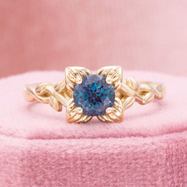 This yellow gold floral engagement ring features an alexandrite at the center of it's petals.