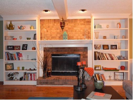 Custom Made Bookshelves Flanking A Fireplace