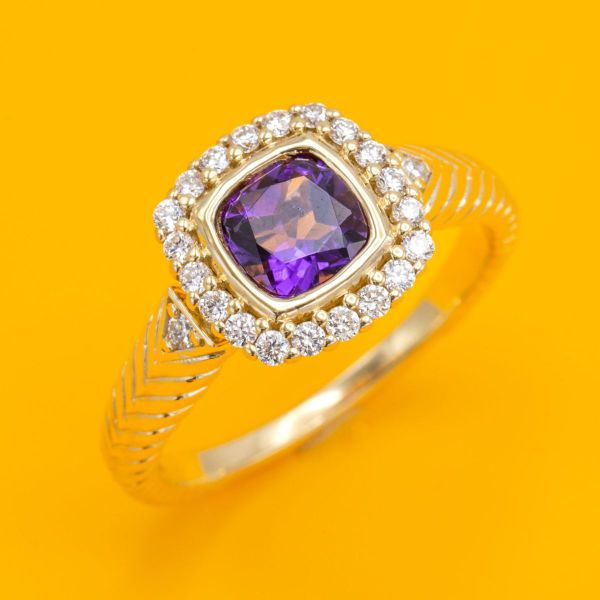 Art Deco styling takes center stage in this cushion cut amethyst and diamond halo engagement ring.