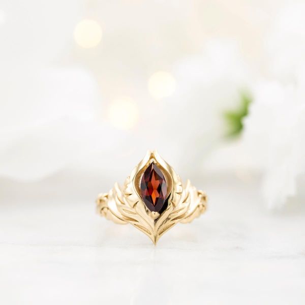 A bold, sculptural setting for marquise red garnet, inspired by an intricate video game emblem.