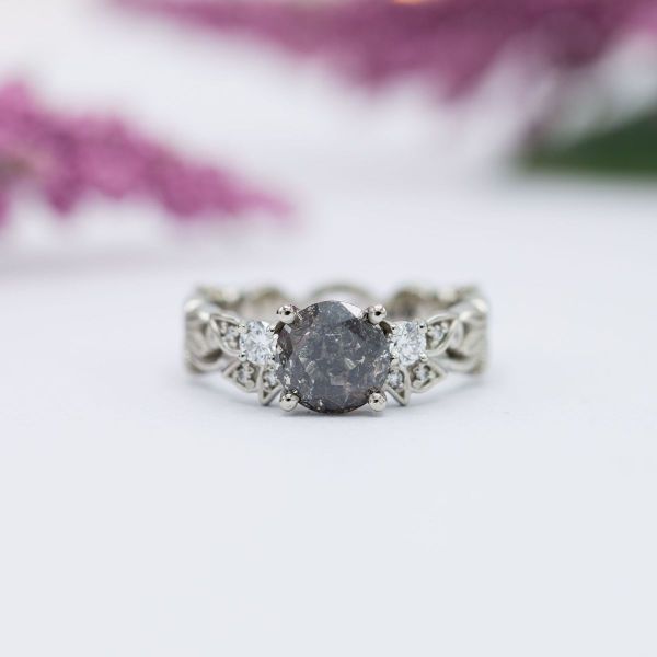 This salt and pepper diamond has a darker background with many deep gray inclusions.