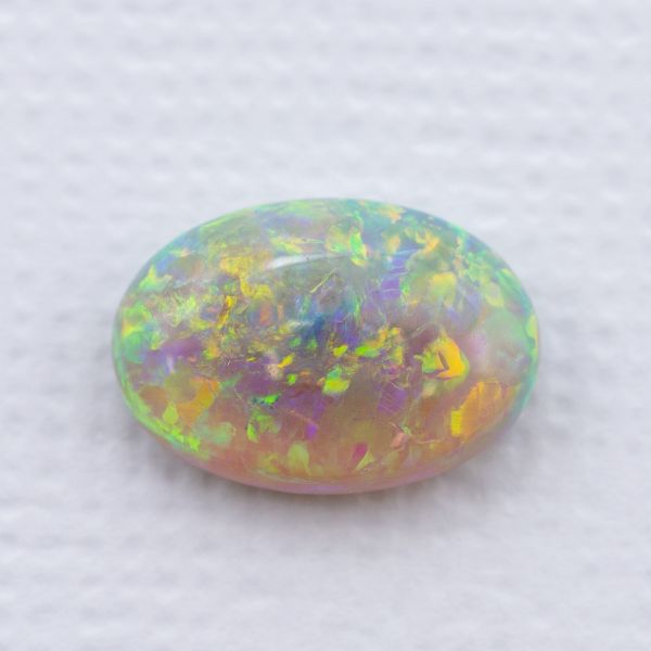 Crystal opal with an open, translucent body and green, yellow, and blue flash.