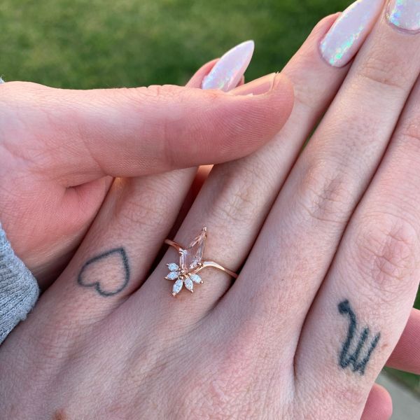 Diamonds accent the elongated morganite kite on this rose gold ring.