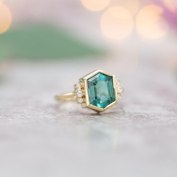 A stunning elongated hexagon tourmaline and diamond accents are set in yellow gold.