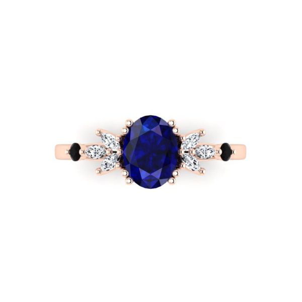 This engagement ring’s oval cut blue sapphire rests in four sets of rose gold double-prongs between petal-like marquise cut diamond accents.