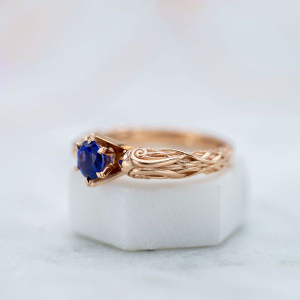 This Ravenclaw ring features Celtic tangles, a hallows inspired symbol, and a stunning blue sapphire.