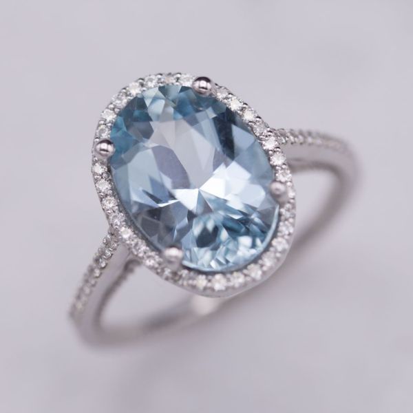 From the top, the perfect contemporary halo ring: delicate pave shank, delicate diamond halo, big oval center stone. From the side, the ring reveals gorgeous vintage-inspired details: bead detailing, filigree on the basket setting. And the aquamarine is truly special: precision-cut to maximize light movement.