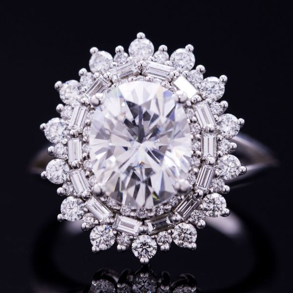 四种尺寸的钻石创造了密集和美丽的光环层。长方形宝石晕是典型的典故。