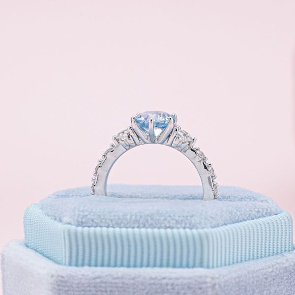 Peekaboo butterflies are hidden beneath the accent stones of this aquamarine and diamond engagement ring.