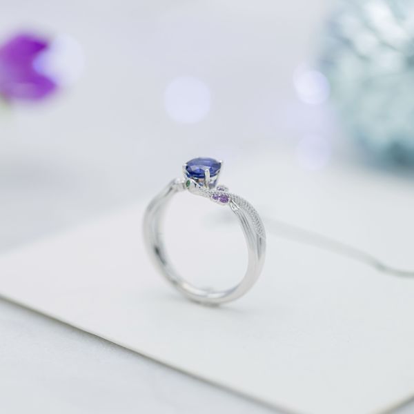 Sapphire, amethyst, and emerald come together in this snake inspired engagement  ring.