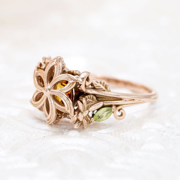 This Lord of the Rings inspired engagement ring feels like autumn with its flower-like center setting and sunset-glow citrine center stone.