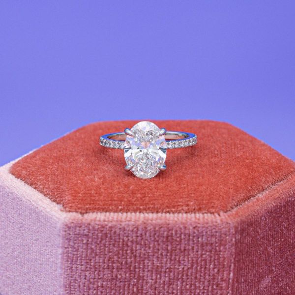 This simple engagement ring features a lab created, oval cut diamond.