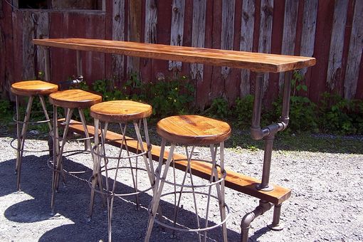 Custom Made Industrial Styled Bar Height Table With A Metal Pipe Base And Salvaged Wood Planks Top
