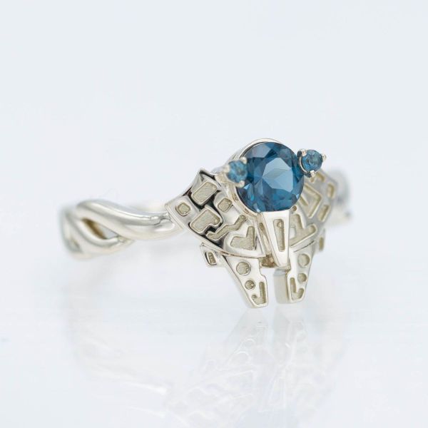 A London blue topaz centers this Star Wars inspired engagement ring, which resembles a Millennium Falcon.
