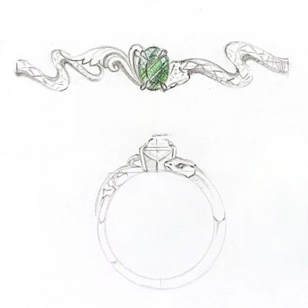 A green tourmaline sits at the center of this snake inspired engagement ring.