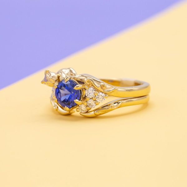 A lab created sapphire is caught by a playful cat in this engagement ring.