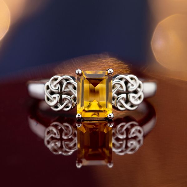 This ring frames an emerald cut citrine with Celtic knots white gold.
