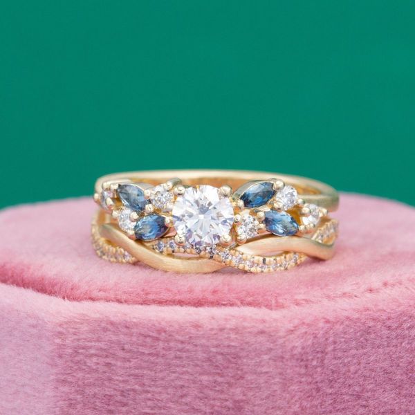 One large diamond is the center of this yellow gold and London blue topaz cluster ring.