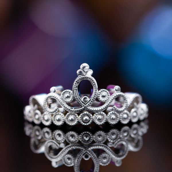 A minimalist take on the classic crown ring skips the gems and uses bead detailing where the eye would expect diamonds.