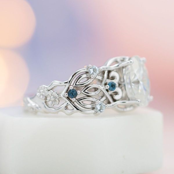This stately Lord of the Rings inspired engagement rings features an oval moissanite center stone and London blue topaz and aquamarine accents.