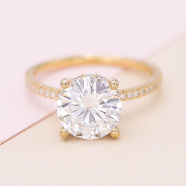 This moissanite-filled engagement ring is all about the sparkle with a peekaboo trinity knot.