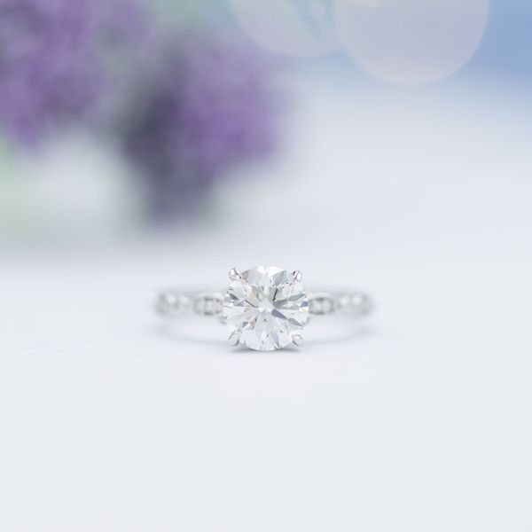 The diamond centerpiece of this beautiful solitaire ring cost around $14,000 alone, before the setting and pavé accents (another $2,000 or so).