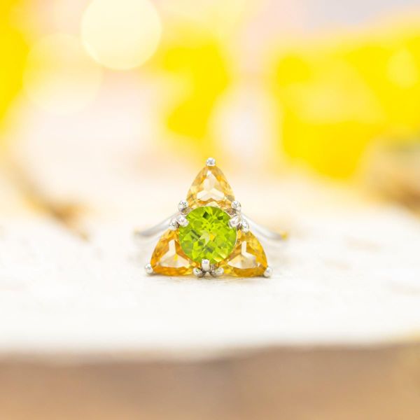 Zelda-inspired engagement ring, creating a Triforce-themed shape with peridot and imperial topaz.