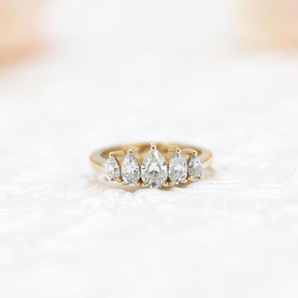This graduated array of 5 pear-shaped moissanites gives this engagement ring a bit of tiara styling.