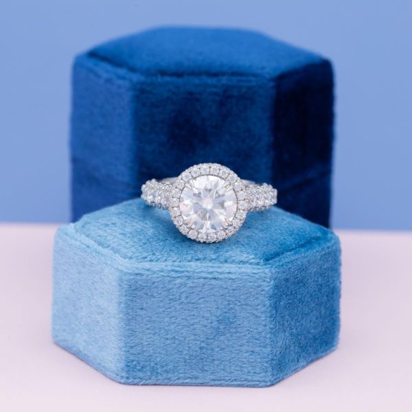 A round cut moissanite in a halo setting.