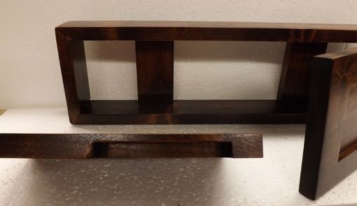 wooden shelf above bathroom sink