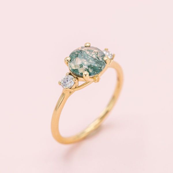 A life-long love of the cello is honored in this moss agate and diamond engagement ring.