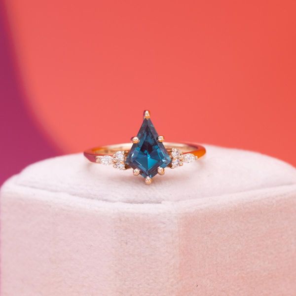 A kite cut alexandrite gives this engagement ring a unique touch.