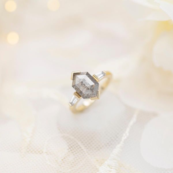 Modern engagement ring, featuring a hexagon cut salt and pepper diamond and baguette diamond side stones.