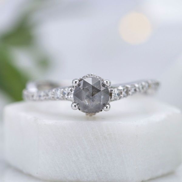 A dramatic salt and pepper rose cut diamond is paired with white diamond accents to put a twist on a diamond solitaire.