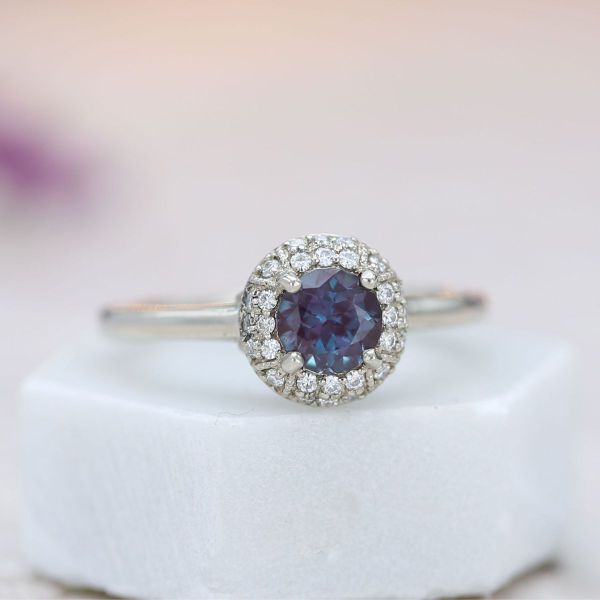 This Batman inspired ring features a deep purple alexandrite center stone and hidden bat logos in the gallery.