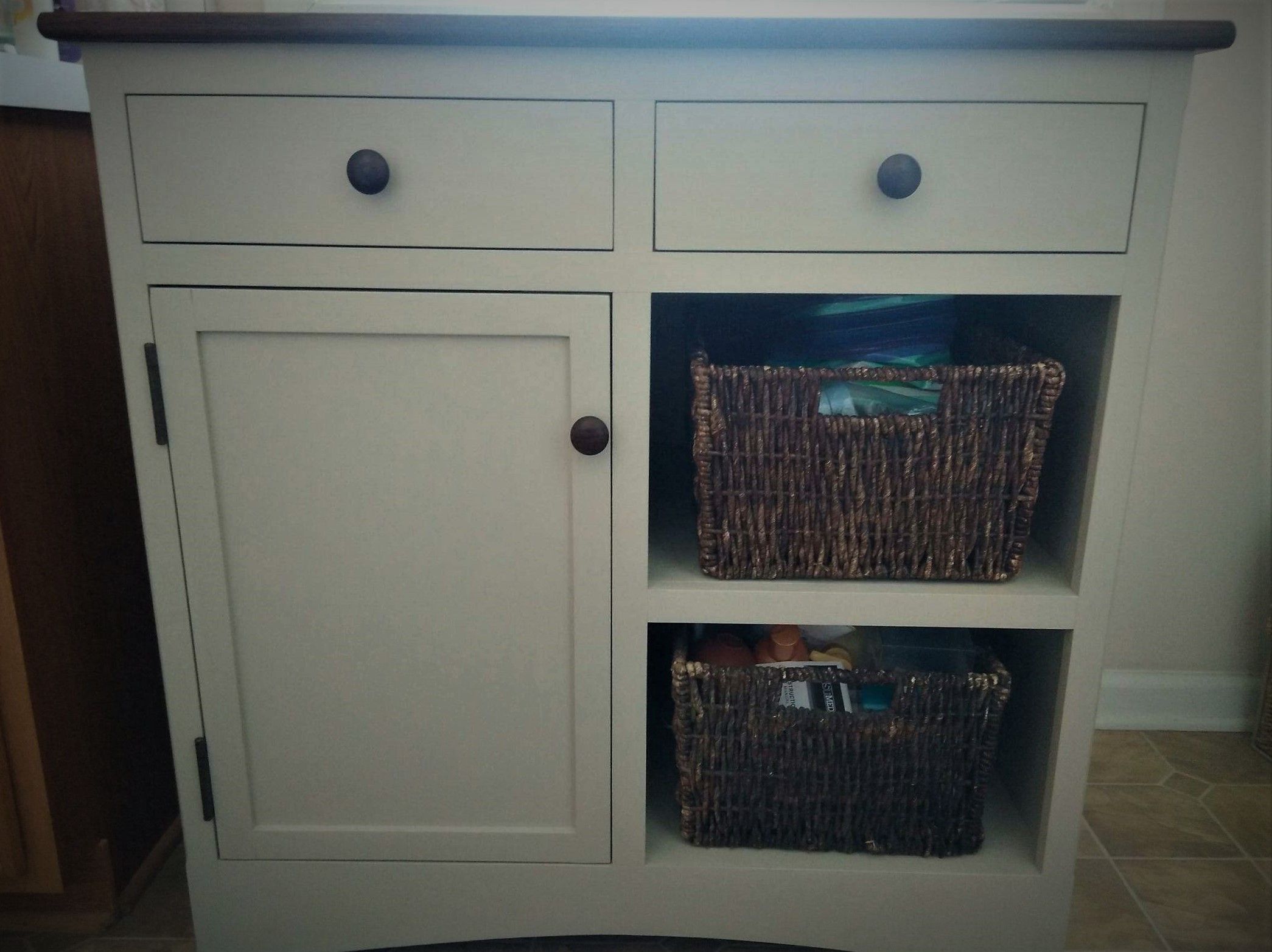 White bathroom cabinet with baskets