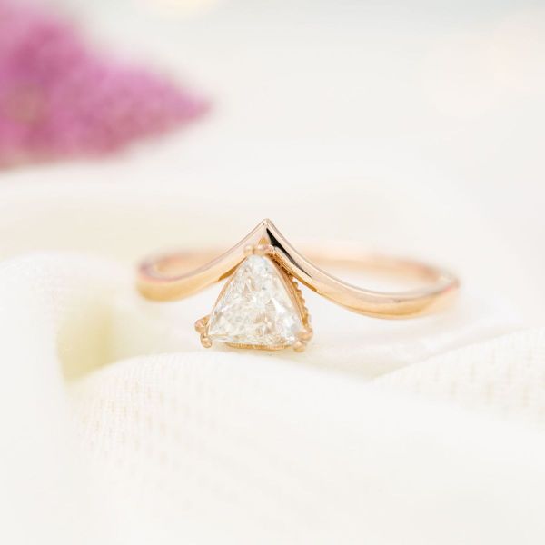 A trillion cut diamond puts a unique spin on the classic diamond solitaire engagement ring.