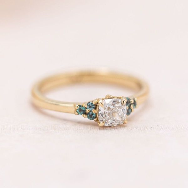 The dragonfly peekaboo on this lab created diamond and alexandrite ring is a secret surprise from the ring's profile.