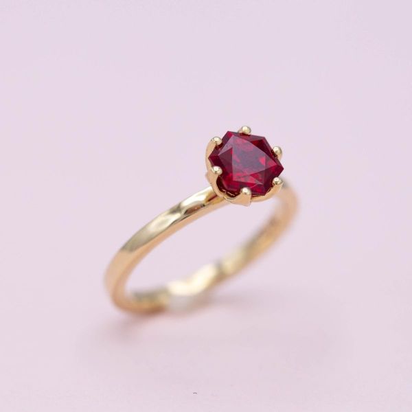 The stunning ruby is set in yellow gold with a twist.