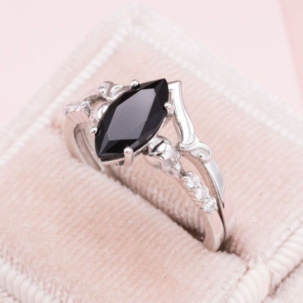The black onyx marquise cut center stone is paired with diamonds that hold a special meaning.