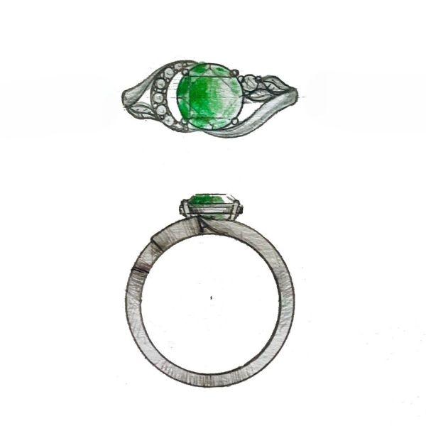Moissanite accents create the crescent moon shape next to the center emerald.