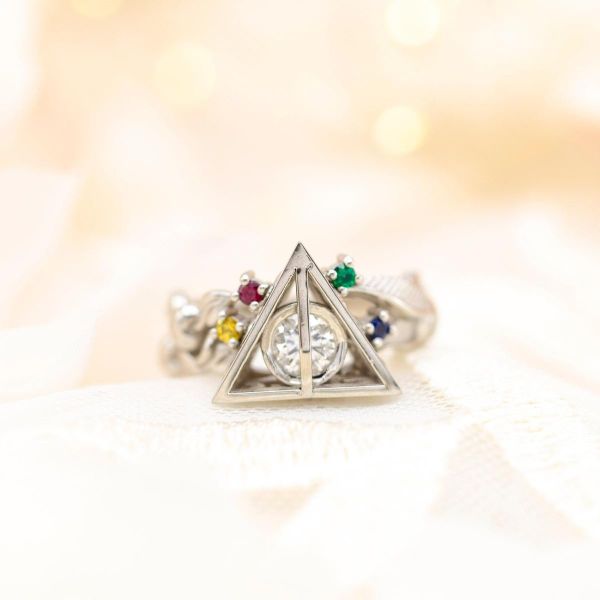 All four Hogwarts houses are represented in this deathly hallows engagement ring.