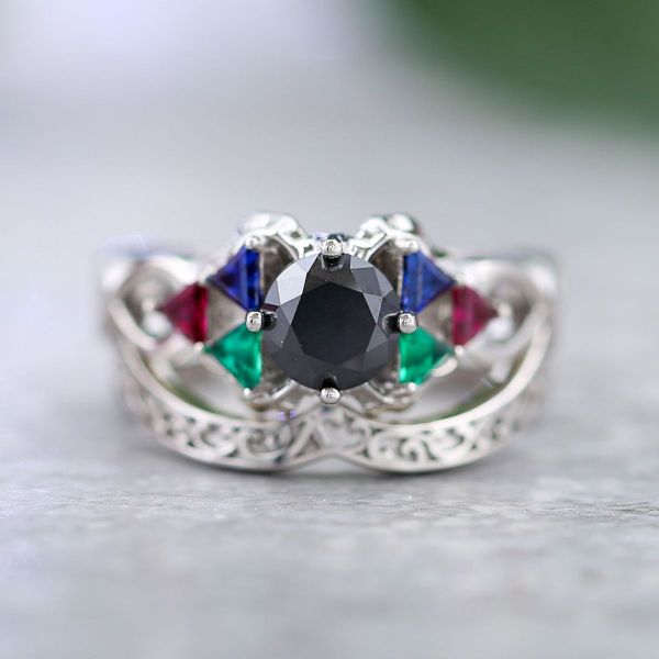 Triangular accent gemstones resemble two Triforces in this Zelda inspired engagement ring with a black diamond center stone.