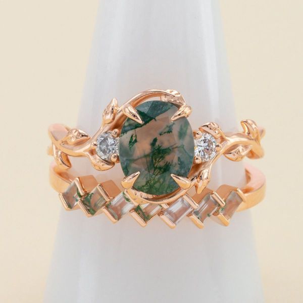 A different take on autumn inspiration, the moss agate center stone and accents on this bridal set pop against the white diamond accents and rose gold bands.