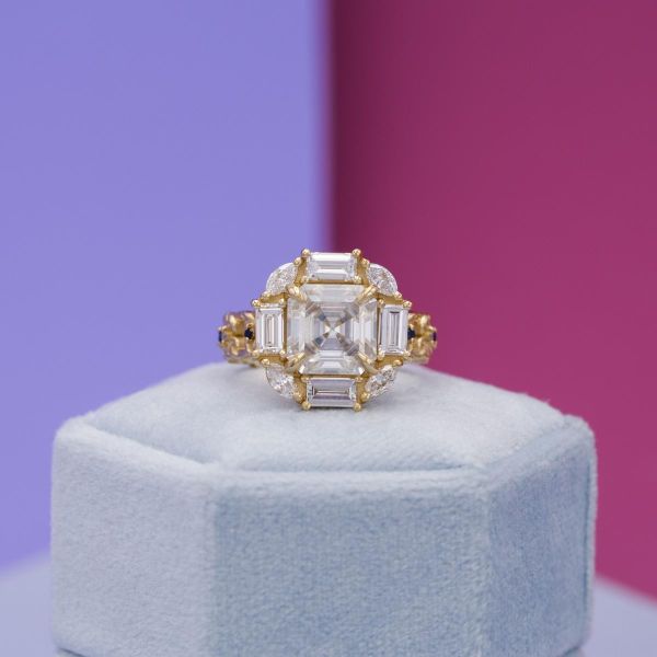 This Asscher cut moissanite sits in a unique yellow gold setting.