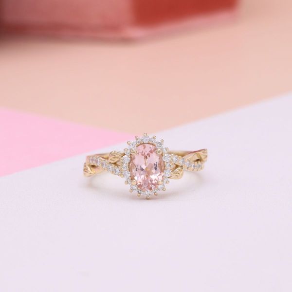 A light pink morganite center stone with a diamond halo.
